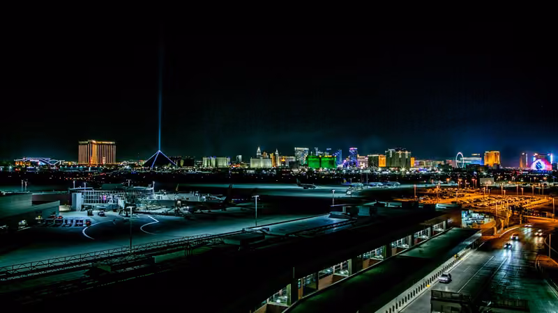 Harry Reid International Airport tarmac with the Las Vegas Strip skyline at night