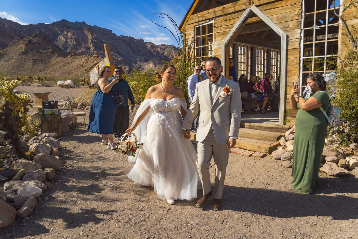 Bride and groom walking out of the vintage chapel at Nelson Ghost Town after their Las Vegas Wedding Chapel ceremony